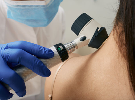 Doctor checking an area on a patient's neck