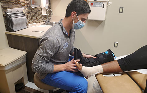 Ben Brown, DO, fits a patient after a successful surgery.