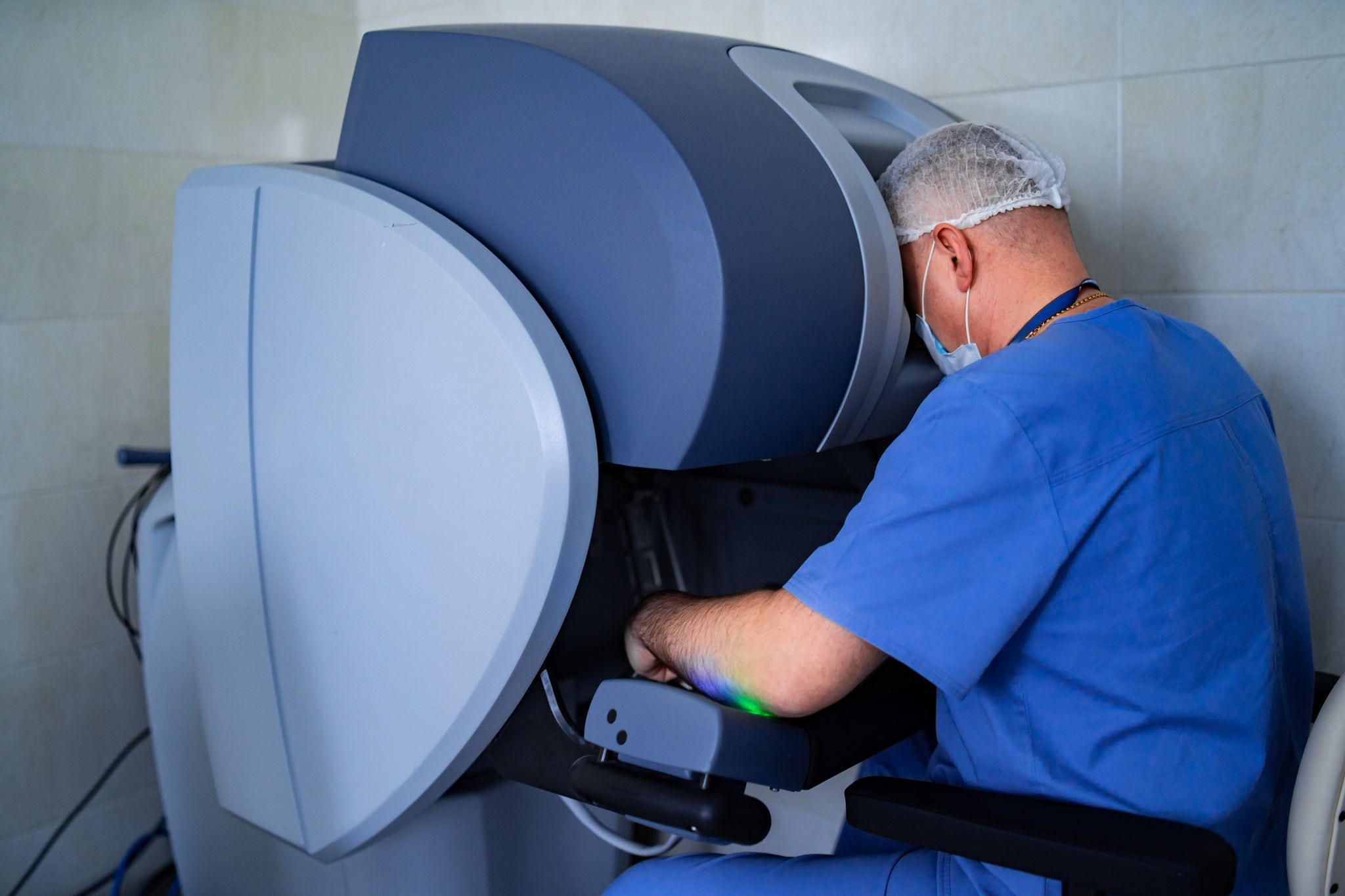Doctor performs minimally-invasive surgeon using a robotic device.