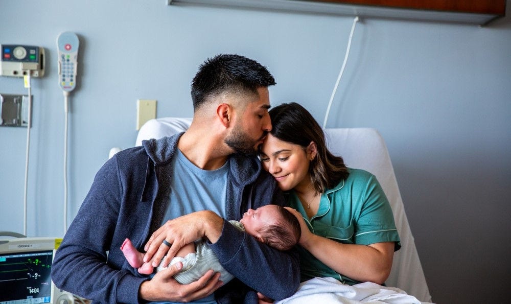 Mother and father with their newborn baby.