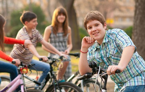 Teenage boy getting ready for a bike ride.