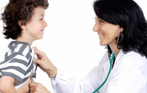 Pediatric cardiologist listens to boy's heart