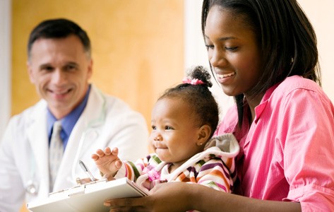 Mother reviews pediatric resources with doctor