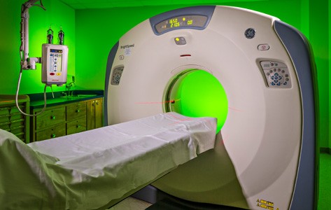 A woman administers a CT scan.