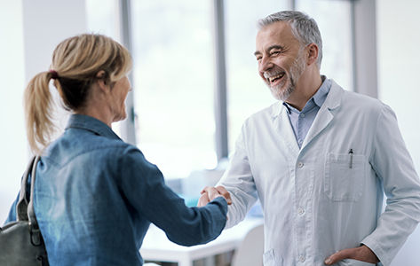 a female patient speaking with her physician in a doctors offic