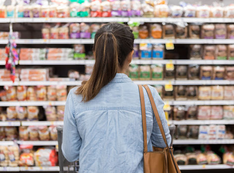 Backview of a woman staring at a grocery shelf