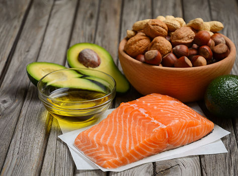 An assortment of healthy fats, including avocado, nuts and salmon