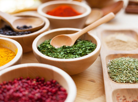 An assortment of spices in bowls which offer health benefits