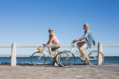  A mature couple having fun with bicycles in outdoor leisure activity.