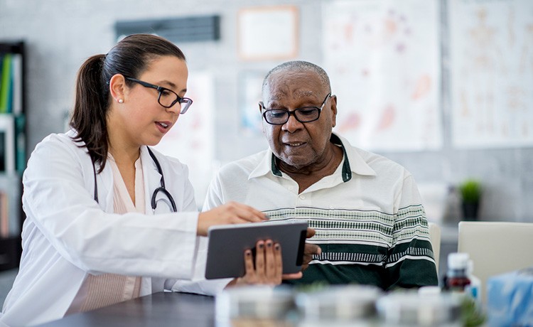 Doctor reviews cancer resources with patient