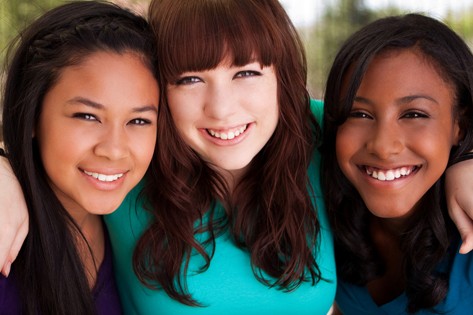 Healthy teenage girls smiling together
