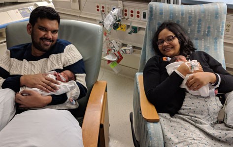 Parents hold premature twins in Overlook Maternity Center