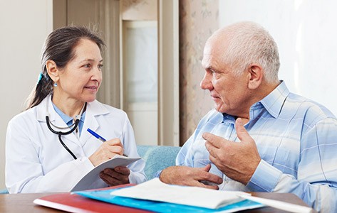 Doctor discusses cancer rehab with patient