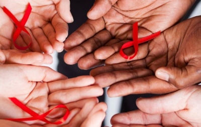 Hands holding AIDS ribbons