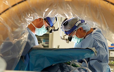 Surgeons perform spine surgery