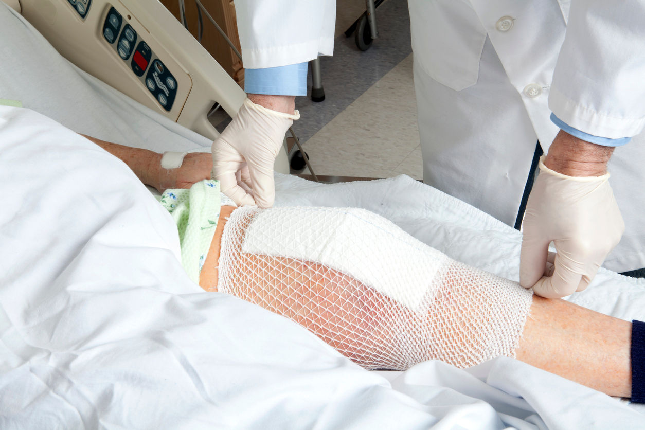 Doctors treating a leg wound