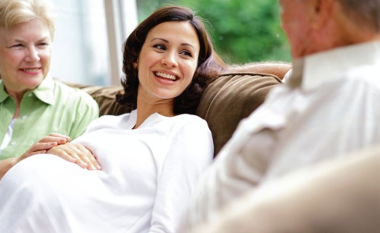 Pregnant woman talking to parents