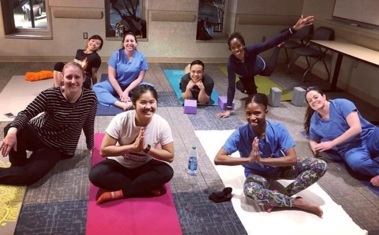 A group of residents enjoy some work and life balance with a yoga class.