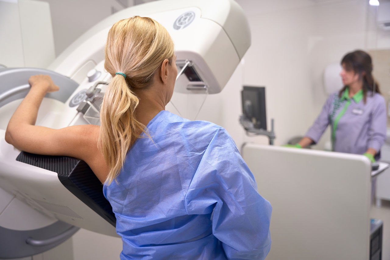 A woman getting a mammogram for early detection.