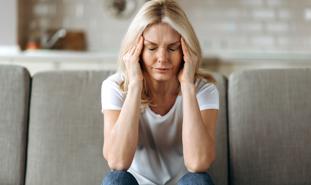 A woman with a headache holding her head