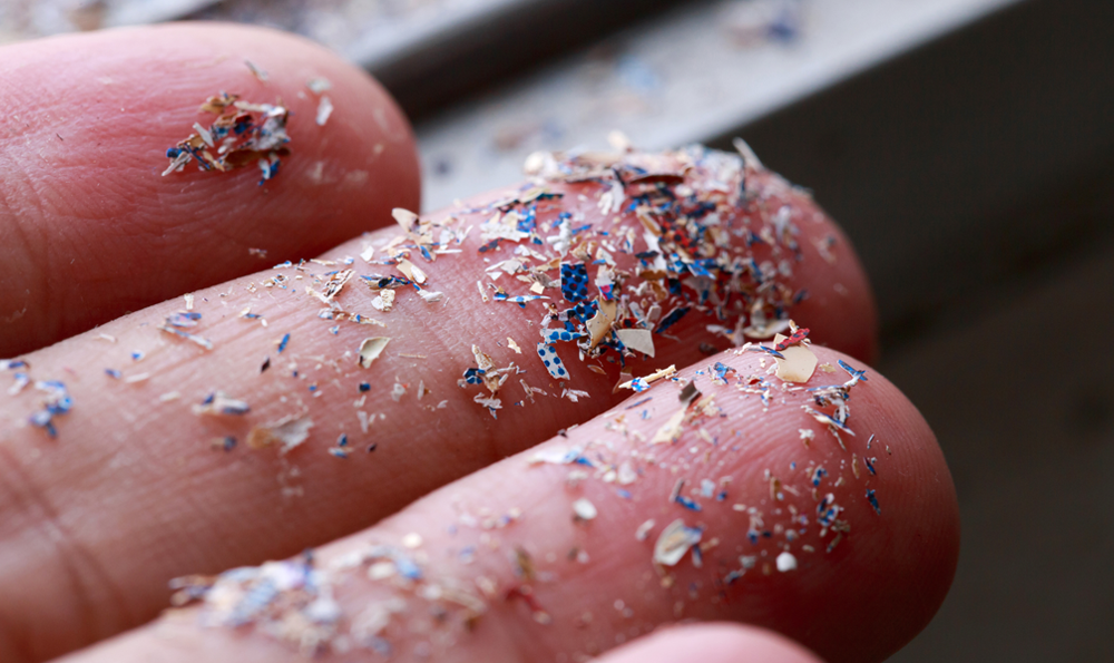A close up of  microplastics on a person's fingers