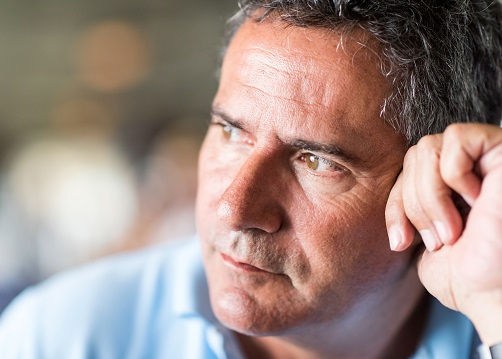 Pensive mature man looking away