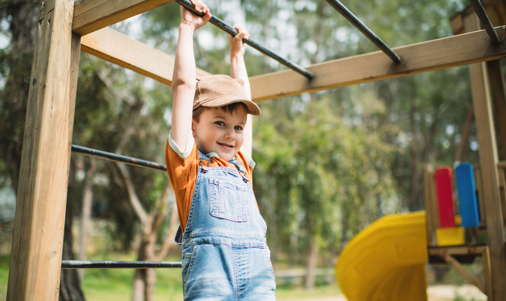 A kid playing in a playground.