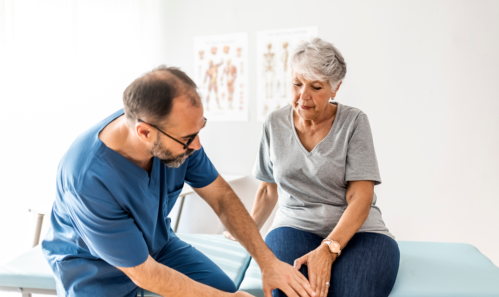 A physician examining a patient's knee