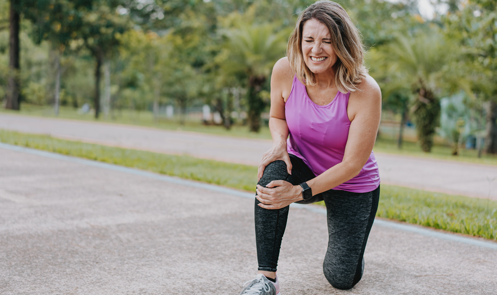 Woman having a muscle strain during workout.