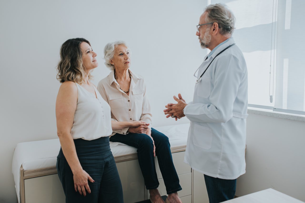 Doctor with patient and caregiver