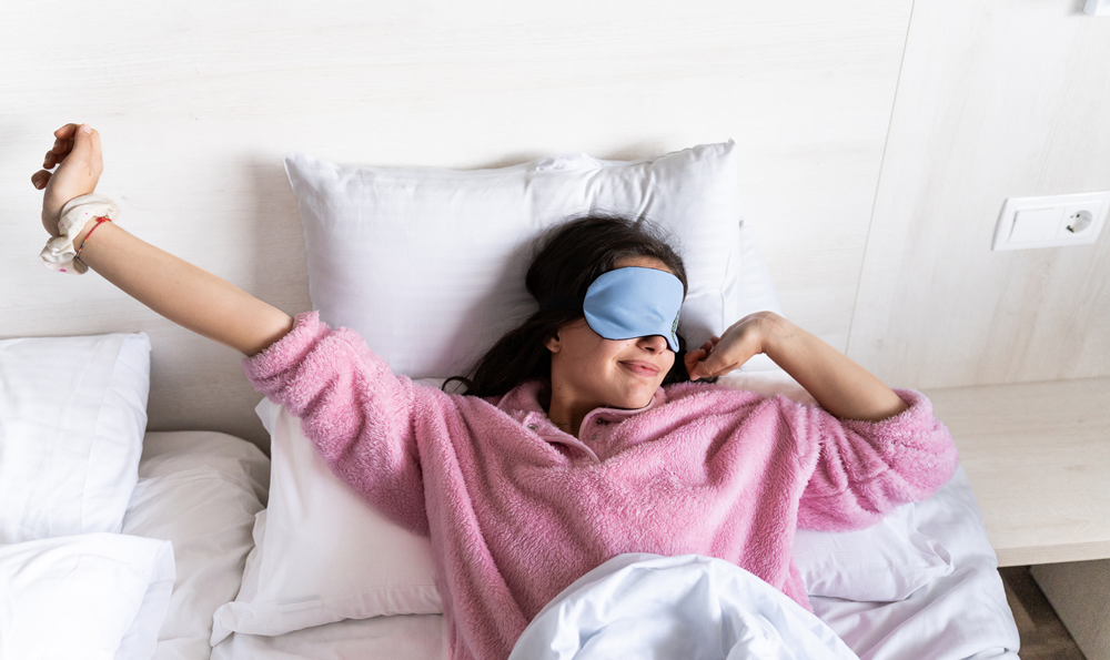 A woman waking up feeling rested.