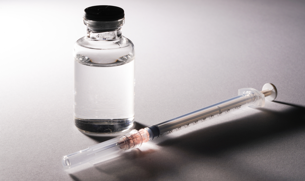 A vial of a weight loss drug and a syringe