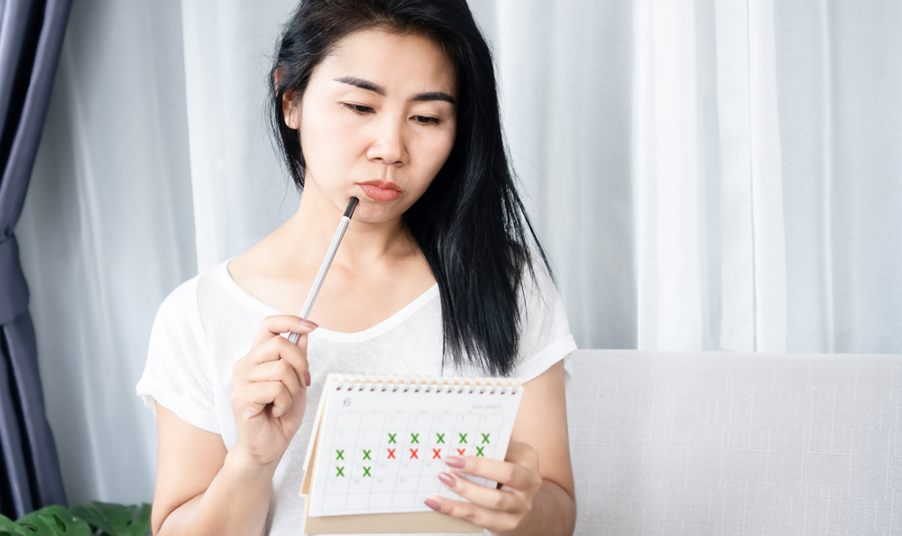 A woman following her menstrual cycle in a calendar.