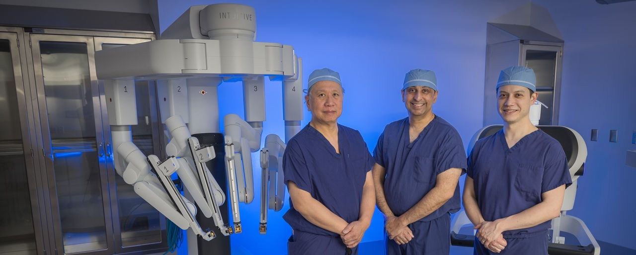 Doctors with robotic surgery machine