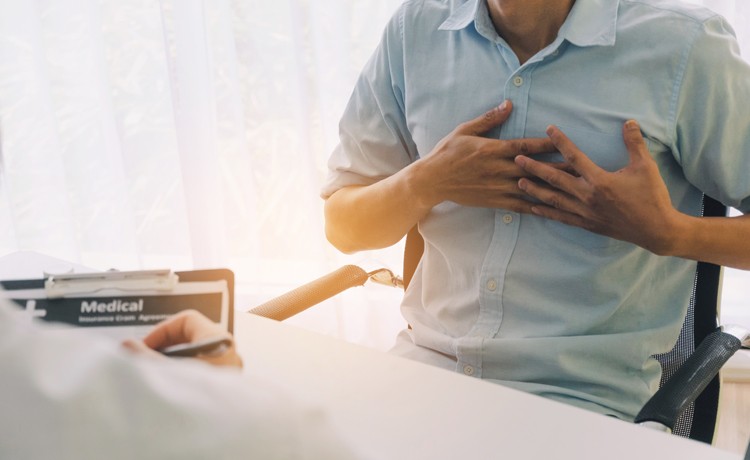 patient describing heartburn to doctor