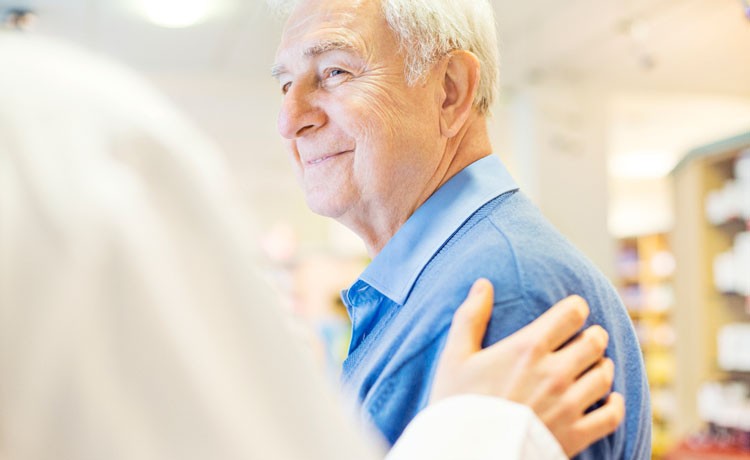 Doctor comforts older patient