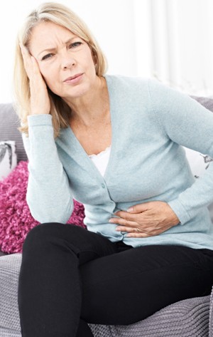 A woman experiencing stomach pain.