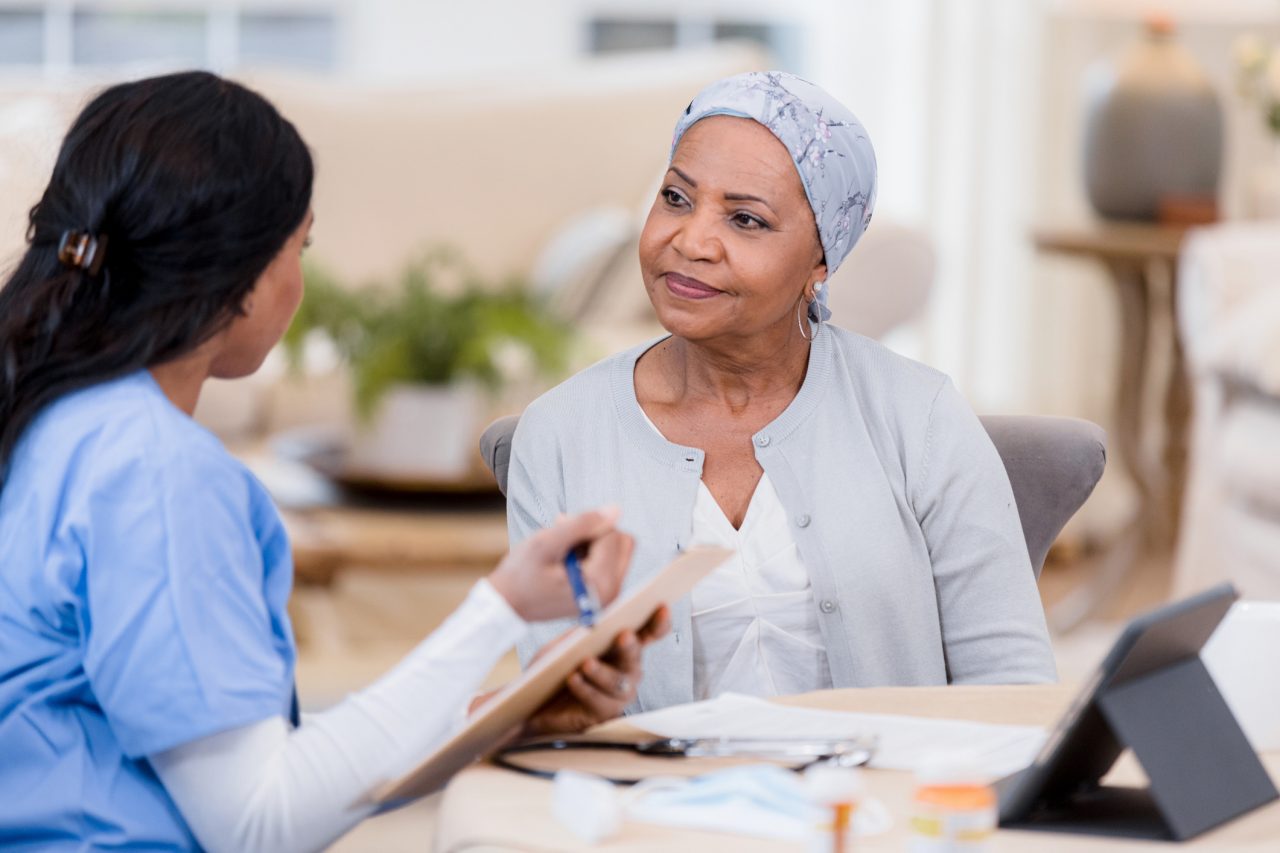 A mature woman consults with her palliative care provider.